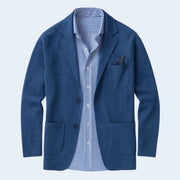 Blue blazer with a striped shirt on a light gray background